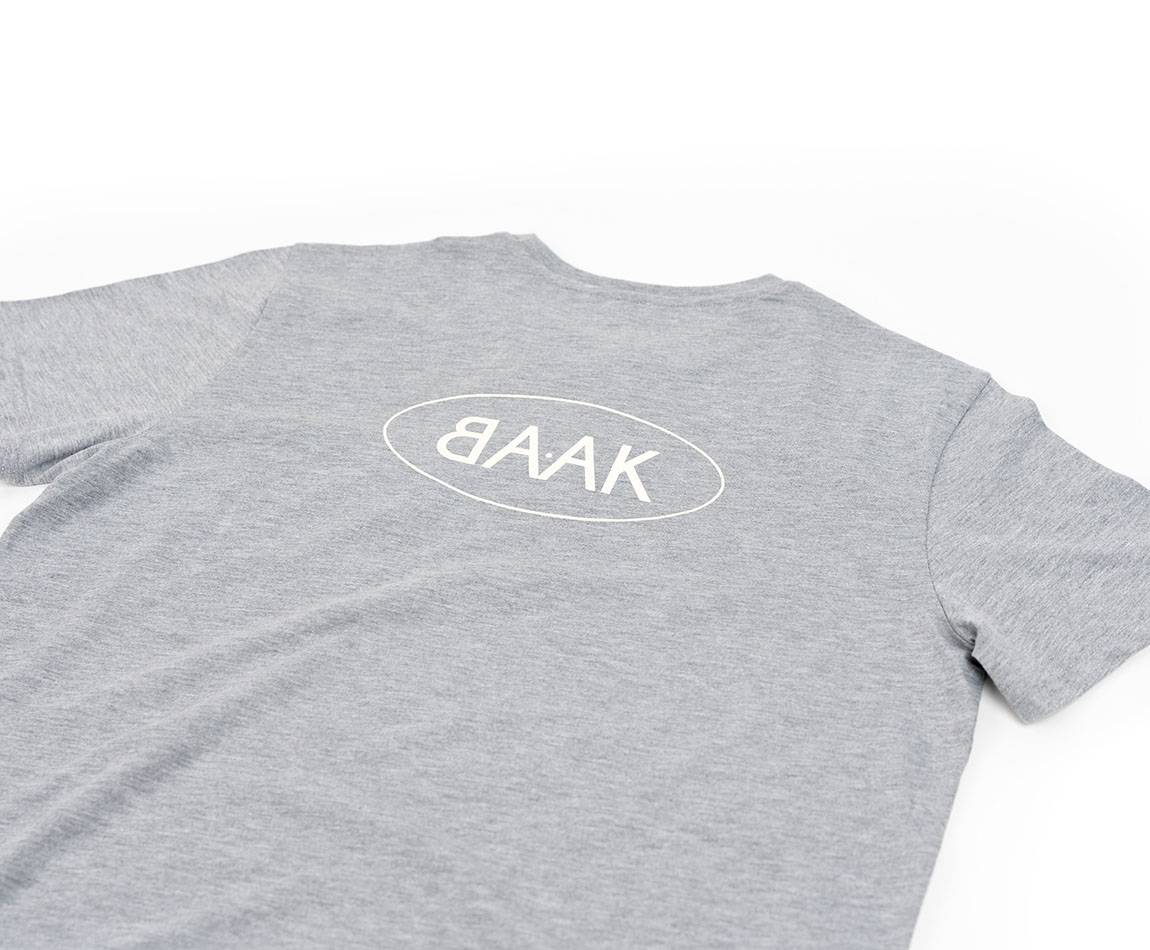 Grey T-Shirt - Short sleeves - Heart pocket on front - Screen-printed cream BAAK logo on back Grey T-Shirt - Short sleeves - Heart pocket on front - Screen-printed cream BAAK logo on back