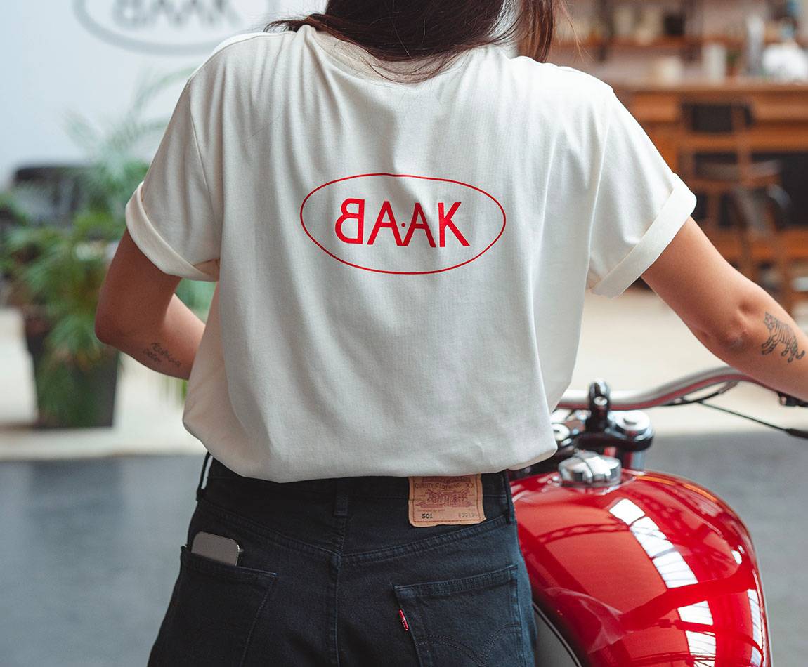 Cream T-Shirt - Short sleeves - Heart pocket on front - Screen-printed red BAAK logo on back Cream T-Shirt - Short sleeves - Heart pocket on front - Screen-printed red BAAK logo on back
