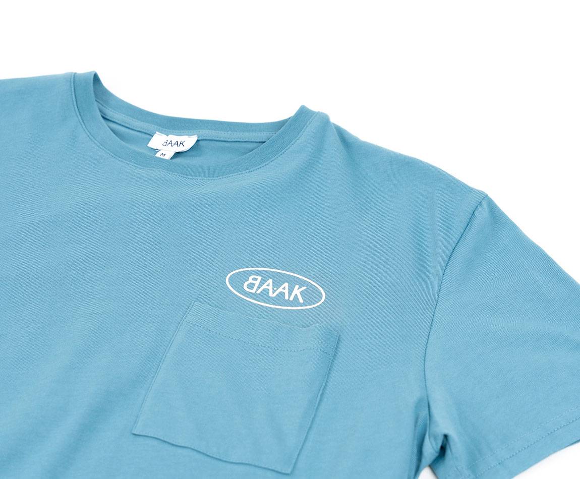 Blue T-Shirt - Short sleeves - Heart pocket on front - Screen-printed cream BAAK logo above pocket Blue T-Shirt - Short sleeves - Heart pocket on front - Screen-printed cream BAAK logo above pocket