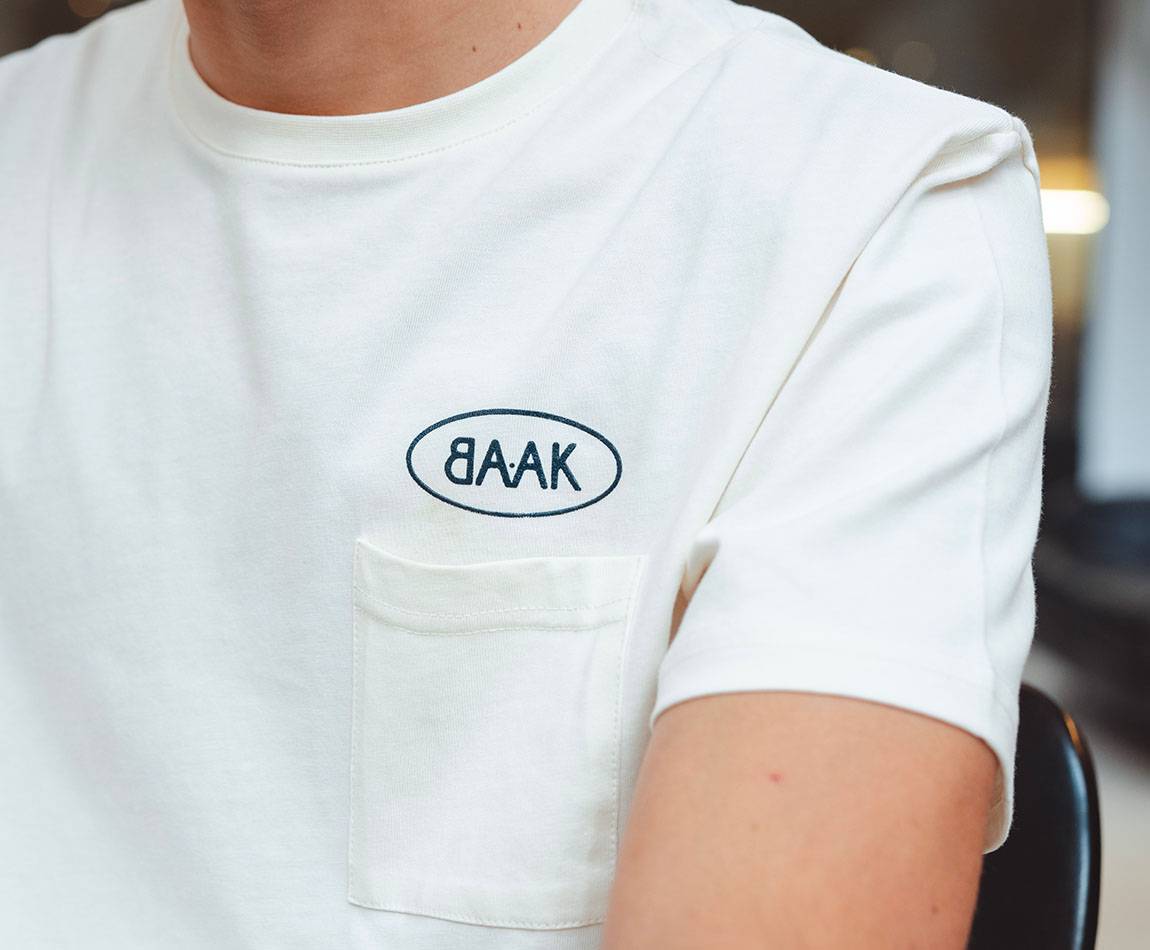 Cream T-Shirt - Short sleeves - Heart pocket on front - Petrol blue BAAK logo silk-screened above pocket Cream T-Shirt - Short sleeves - Heart pocket on front - Petrol blue BAAK logo silk-screened above pocket
