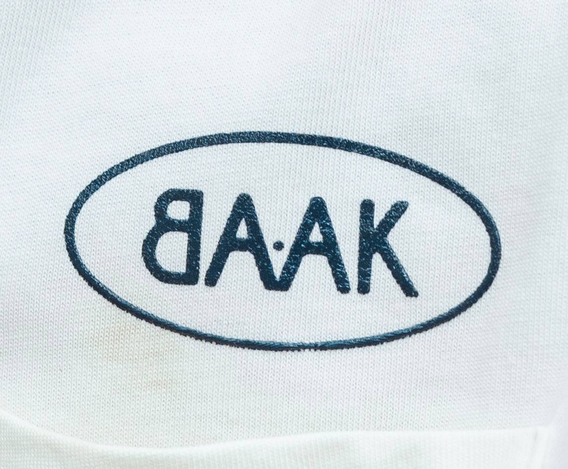 Cream T-Shirt - Short sleeves - Heart pocket on front - Petrol blue BAAK logo silk-screened above pocket Cream T-Shirt - Short sleeves - Heart pocket on front - Petrol blue BAAK logo silk-screened above pocket