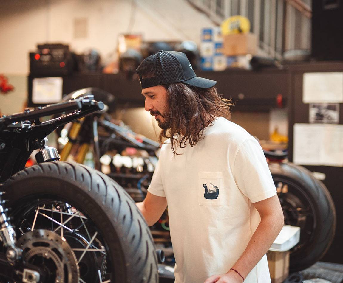 Cream T-Shirt - Short sleeves - Heart pocket on front - Silk-screened petrol blue helmet motif on pocket Cream T-Shirt - Short sleeves - Heart pocket on front - Silk-screened petrol blue helmet motif on pocket