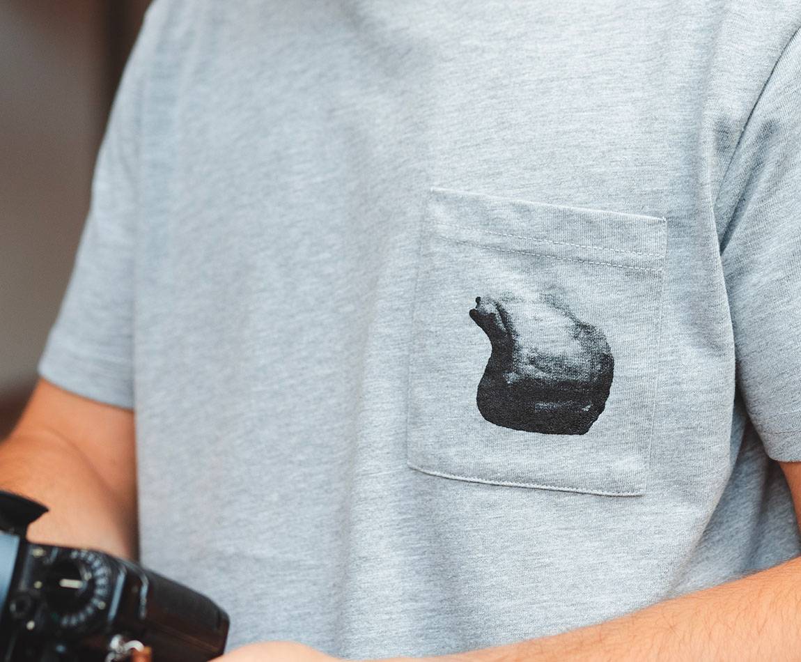 Grey T-Shirt - Short sleeves - Heart pocket on front - Black helmet silk-screen print on pocket Grey T-Shirt - Short sleeves - Heart pocket on front - Black helmet silk-screen print on pocket